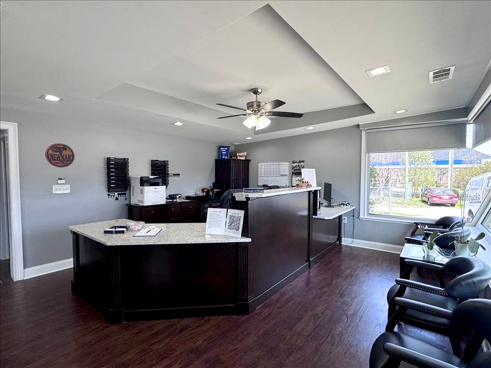 Modern office reception area with desk and seating